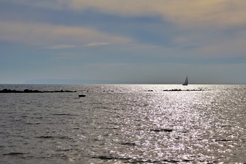 Panoramic view of a sailboat sailing near the coast of Alicante in the Mediterranean Sea