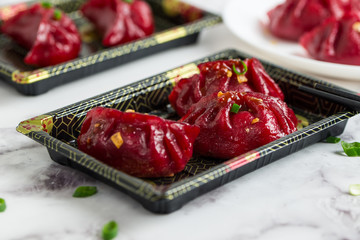 Pan fried beetroot pot stickers with spicy sauce