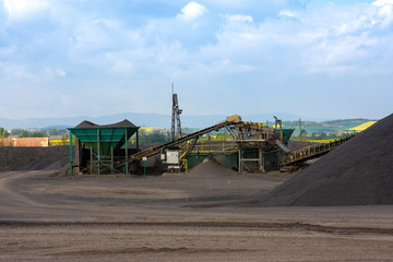 Fototapeta premium View of open-pit mine machinery with sifters and belt conveyors in basalt quarry