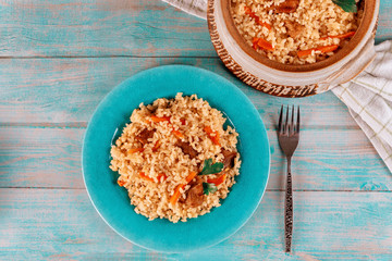Thai rice with meat and vegetable on blue plate.