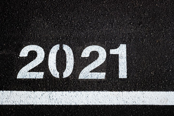 Background with the letters of the new year 2021 on urban asphalt.