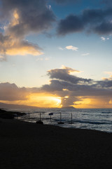 Long exposure seascapes of White Plains Beach at sunrise on Oahu Hawaii monotone and color blurred...