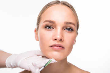 Beautiful young woman gets beauty injection in eye area from sergeant isolated over white...