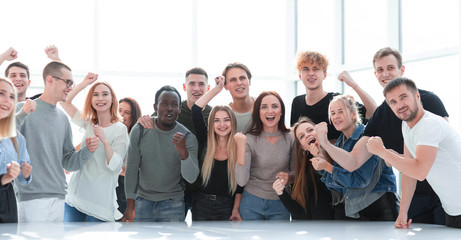 large group of happy young people standing together