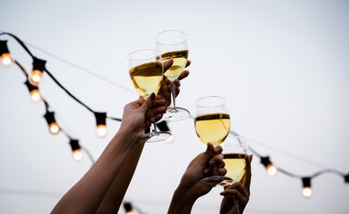 Cheers! Group of people cheering with champagne flutes with party background, Concept Celebration.