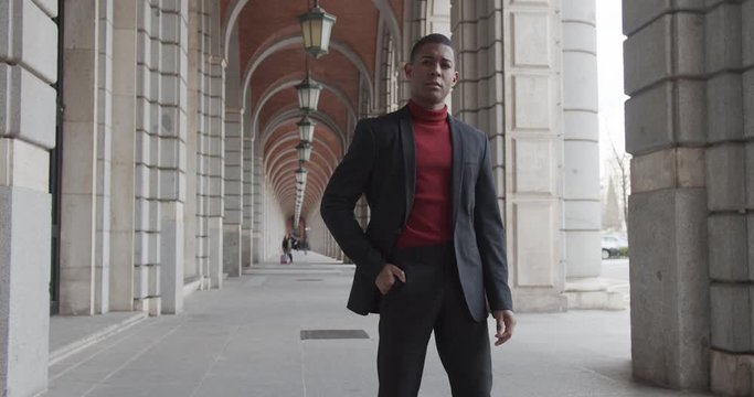 attractive black Hispanic young guy male businessman successful manager in a classic suit look at the camera