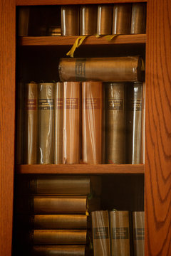 Wooden shelves with classic books in French. Shakespeare complete collection.