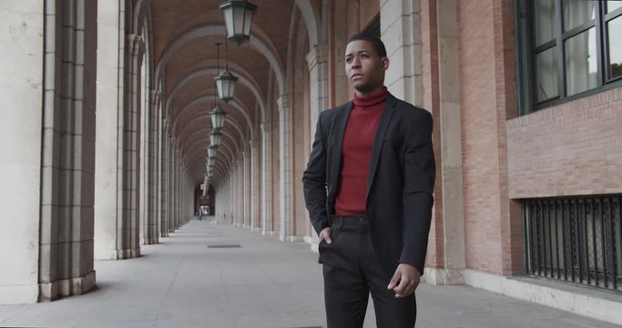 attractive black Hispanic young guy male businessman successful manager in a classic suit posing 