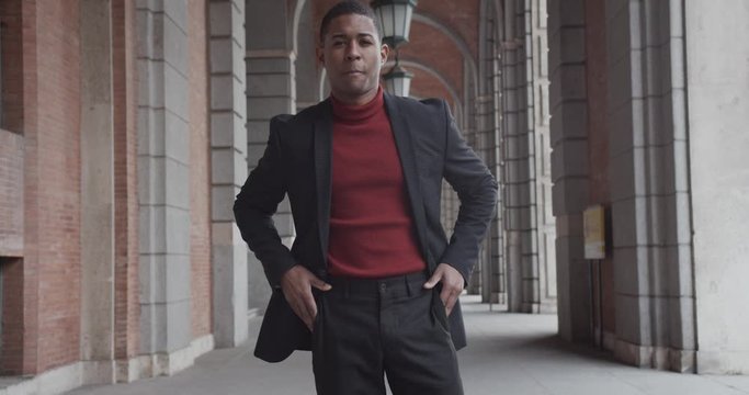 attractive black Hispanic young guy male businessman successful manager in a classic suit posing and looking at the camera