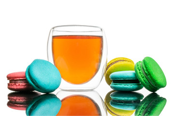 Glass cup black tea, macaroons cookies Isolated on white. Colorful and sweet French macaroons background