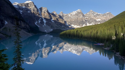 early morning view of reflections on moraine lake in banff np, canada