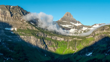 morning time shot of mist clearing from mt oberlin and logan pass in glacier np