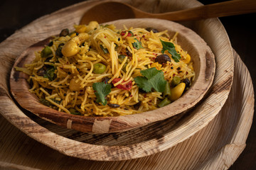 Indian vermicelli upma served in eco friendly palm leaf plate