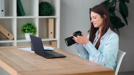 Work from home. The freelancer.
A girl photographer processes photos on a laptop, then picks up the camera in her hands and reviews photos and smiling - Powered by Adobe