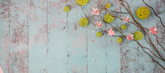 Spring decorations on the wooden background. Some branches, butterflies and more