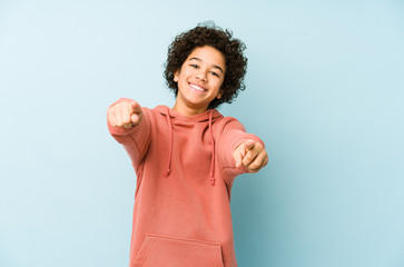 African american little boy isolated cheerful smiles pointing to front. © Asier