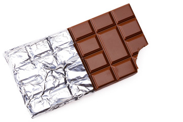 bitten milk chocolate bar in foil isolated on white background. top view
