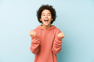 African american little boy isolated cheering carefree and excited. Victory concept.