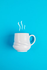 Coffee mug with smoke graphics on a blue background