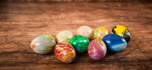 Some Easter eggs in a group on the wooden background. 