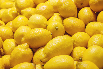 yellow lemons pile in organic food supermarket