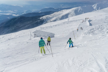 Fototapeta na wymiar Skiers on a slope in the mountains of Slovakia