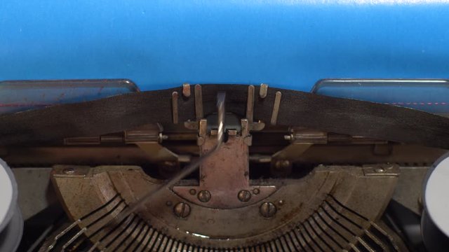 close-up text I AM GAY. old vintage typewriter with a sheet of blue paper
