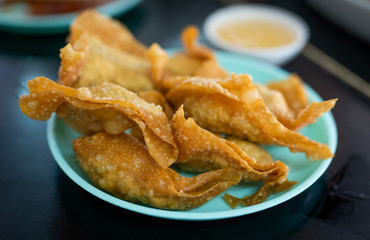 selective focus on oil on fried wonton - unhealthy food concept