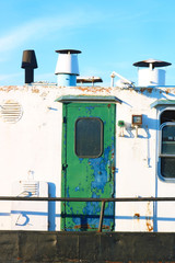 Rusty ship with green door