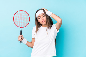 Young caucasic woman playing badminton isolated being shocked, she has remembered important meeting.