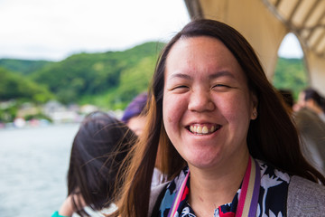 Portraiture image of beautiful young Asian lady with happy smile on a ferry boat at Nami Island (Namiseom), South Korea
