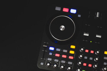 Dj sound mixer controller with knobs and sliders. audio mixing deck with turntables at dark with...