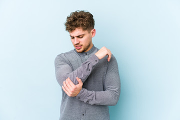 Young blond curly hair caucasian man isolated massaging elbow, suffering after a bad movement.