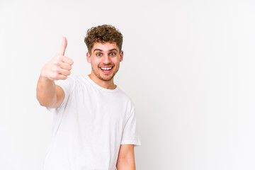 Young blond curly hair caucasian man isolated smiling and raising thumb up