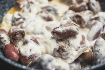 Process of cooking fried roasted grilled chicken hearts with sour cream, fresh raw stewed chicken hearts