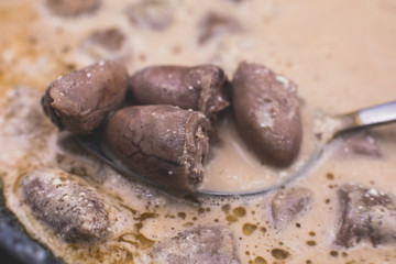 Process of cooking fried roasted grilled chicken hearts with sour cream, fresh raw stewed chicken hearts
