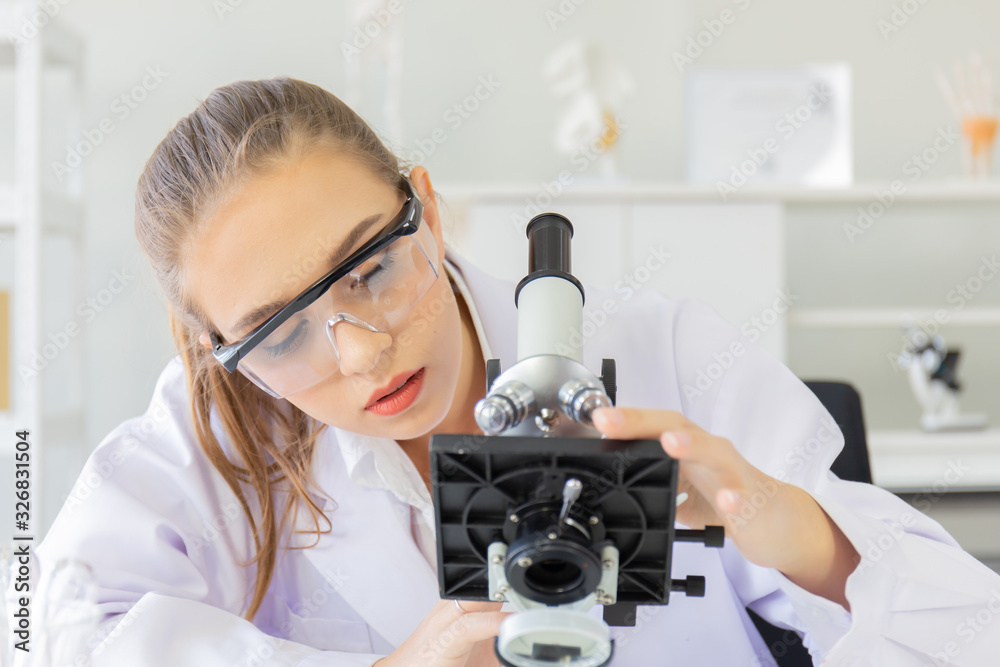 Poster A beautiful female scientist is operating in a science lab with various equipment in the lab.