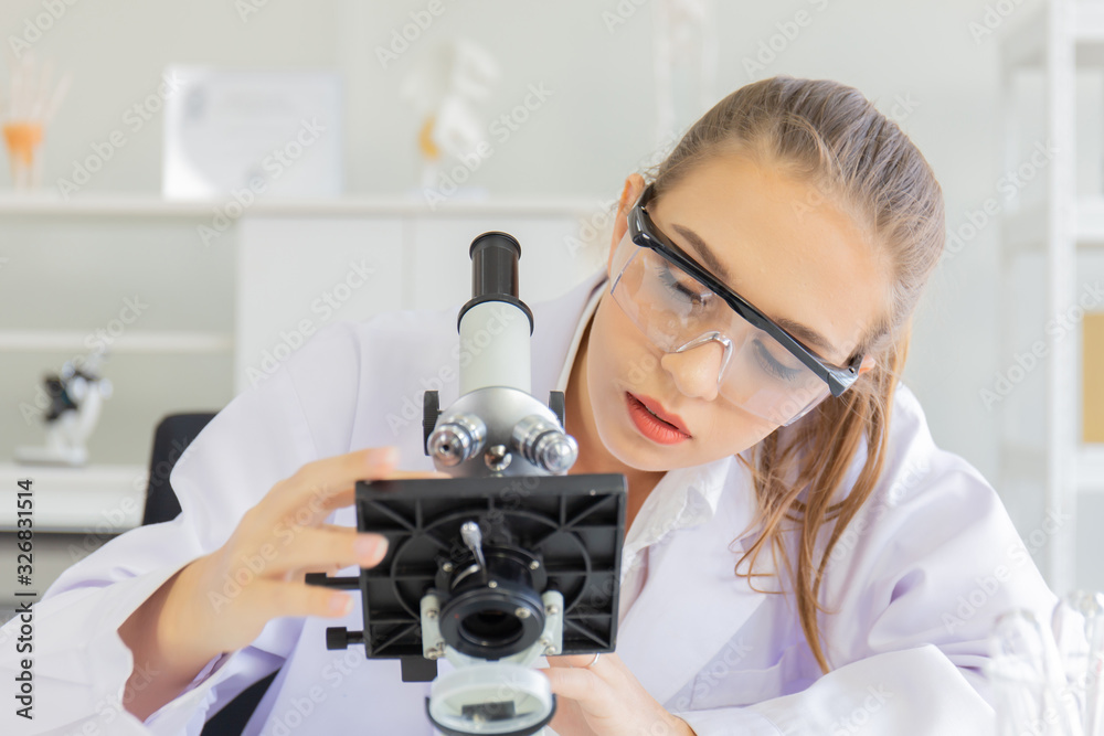 Poster A beautiful female scientist is operating in a science lab with various equipment in the lab.