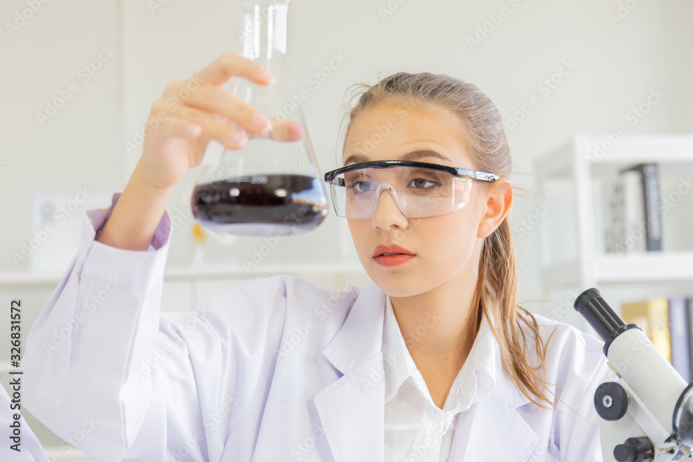 Poster A beautiful female scientist is operating in a science lab with various equipment in the lab.