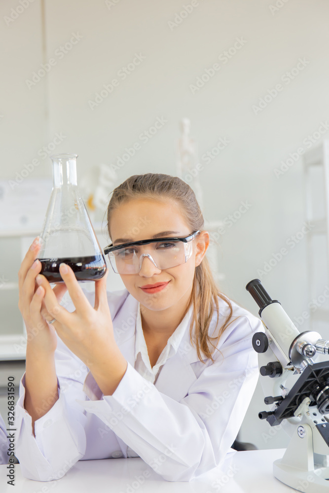 Poster A beautiful female scientist is operating in a science lab with various equipment in the lab.