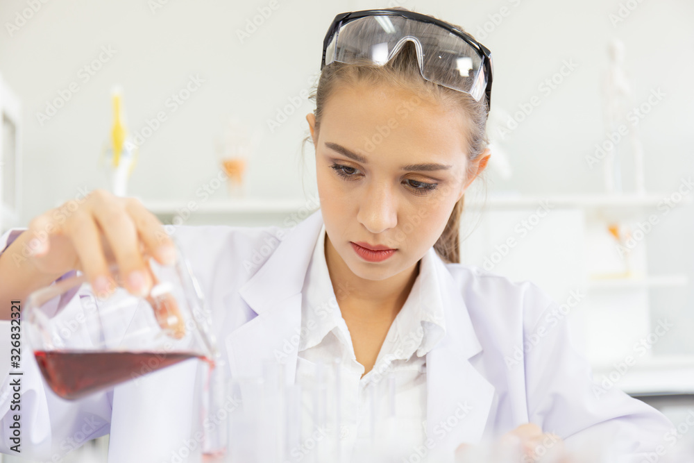 Poster A beautiful female scientist is operating in a science lab with various equipment in the lab.