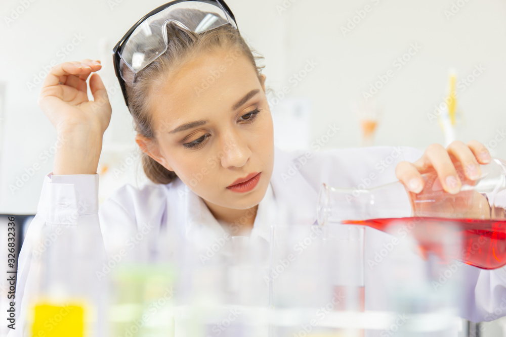 Poster A beautiful female scientist is operating in a science lab with various equipment in the lab.