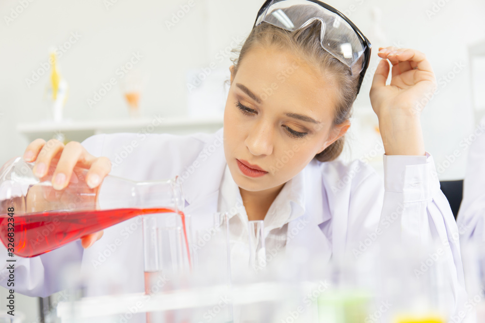 Poster A beautiful female scientist is operating in a science lab with various equipment in the lab.
