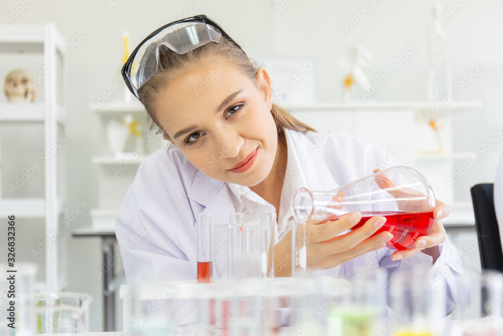 Poster A beautiful female scientist is operating in a science lab with various equipment in the lab.