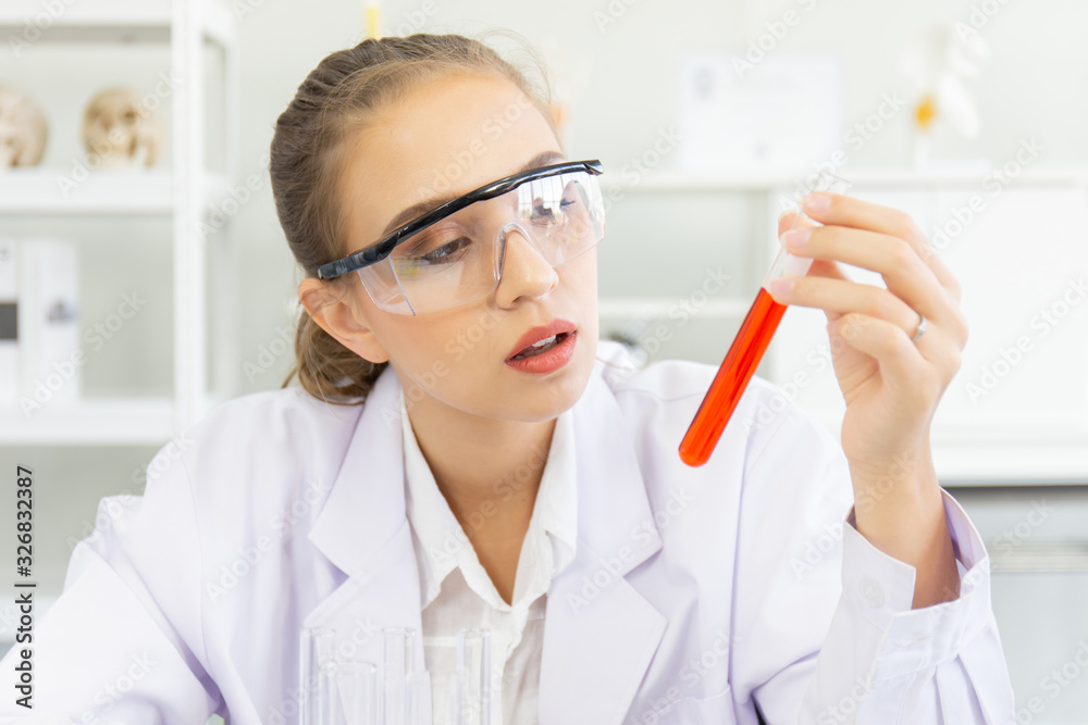 Poster A beautiful female scientist is operating in a science lab with various equipment in the lab.