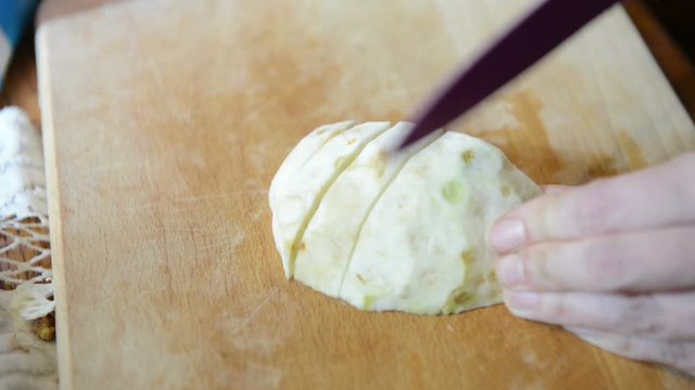 Cutting celery root in pieces on a cutting board. preparing food