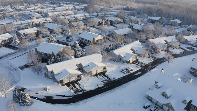 Aerial View Of Residential Houses Covered Snow At Winter Season. Establishing Shot Of American Neighborhood, Suburb.  Real Estate, Drone Shots, Sunny Morning, Sunlight, From Above.