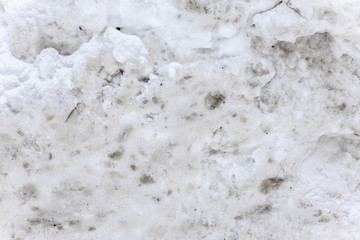 Dirty snow spring background. Spring time. Old and dirty snow texture. Natural background