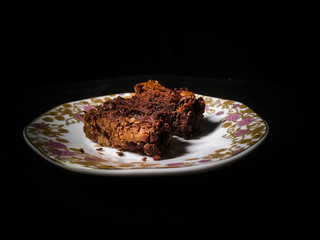Chocolate brownie isolated on black background