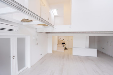 Interior of empty stylish modern open space two level apartment